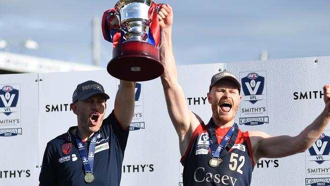 MELBOURNE, AUSTRALIA - SEPTEMBER 18: Mark Corrigan, coach of the Casey Demons and Mitch White of the Casey Demons celebrate after the 2022 VFL Grand Final match between the Casey Demons and the Southport Sharks at Ikon Park on September 18, 2022 in Melbourne, Australia. (Photo by Felicity Elliott/AFL Photos via Getty Images)