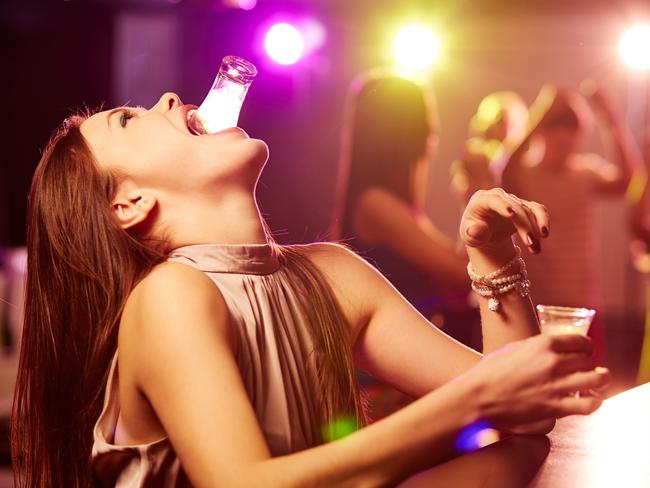 Young woman drinking shots of tequila at bar counter generic. Picture: iStock