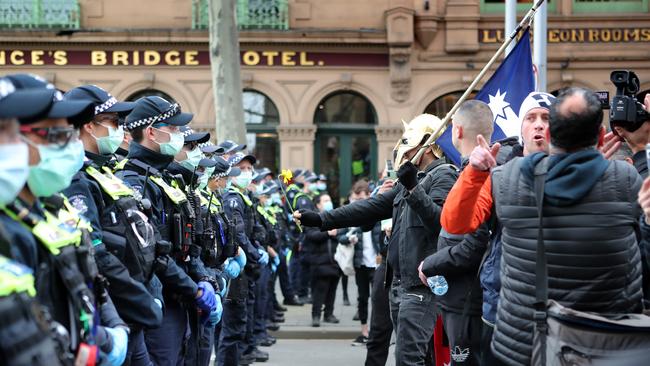 Protesters against the police line outside Flinders Street Station. Picture Rebecca Michael.