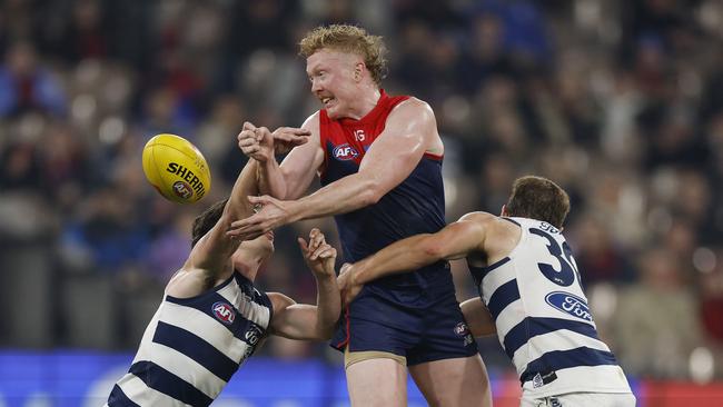 Melbourne’s Clayton Oliver is swarmed by two Geelong opponents. Picture: Michael Klein