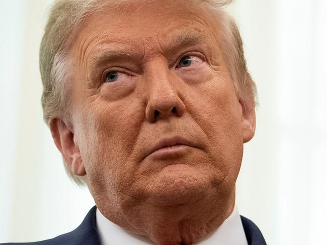 FILE -  US President Donald Trump listens during a Medal of Freedom ceremony for Lou Holtz in the Oval Office of the White House on December 3, 2020, in Washington, DC. (Photo by Brendan Smialowski / AFP)