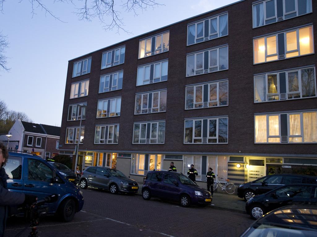 People look at the apartment, bottom right illuminated window, where the suspect was arrested in Utrecht, Netherlands. Picture: AP