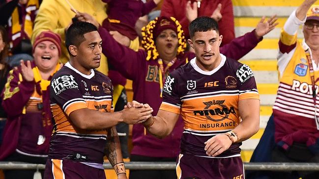 Kotoni Staggs is congratulated by teammate Anthony Milford after scoring a try. Picture: Bradley Kanaris/Getty Images