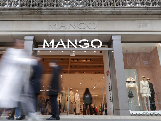 Pedestrians walk by the entrance of a Mango shop on Passeig de Gracia street in Barcelona on February 28. Picture: Lluis Gene/Mango/AFP