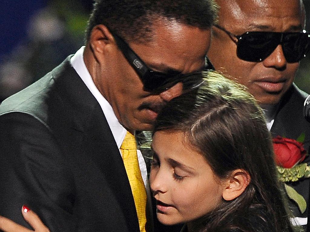  Michael Jackson's daughter Paris is comforted by her uncle Marlon Jackson at a memorial service for the music legend in 2009. Picture: AFP