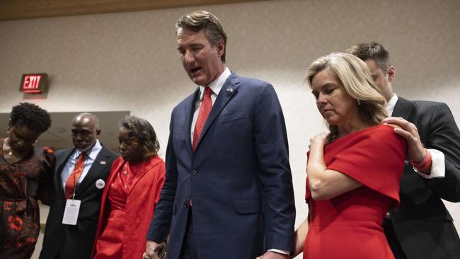 Glenn Youngkin holds hands with Winsome Sears, left, and his wife Suzanne, right, during a group prayer. Picture: AFP