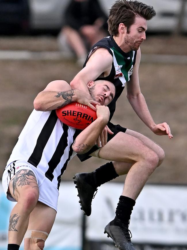 Eastern: Scoresby’s Todd Morgan cops it from Donvale’s Luke Manion. Picture: Andy Brownbill