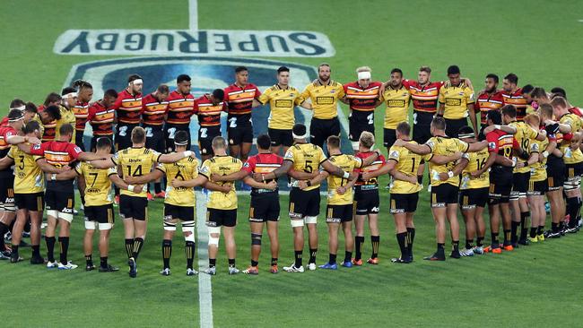 Chiefs and Hurricanes players come together before their match last Friday night to remember the victims of the Christchurch shooting. Picture: Getty Images