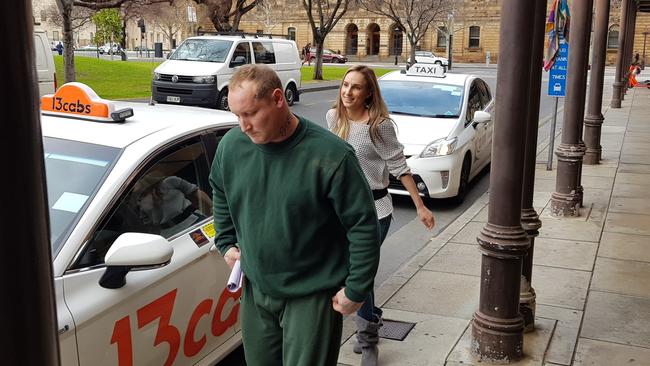 Former Big Brother contestant Saxon Pepper and his partner leave court after he is sentenced to home detention for drug and weapons charges. Picture: Sean Fewster.