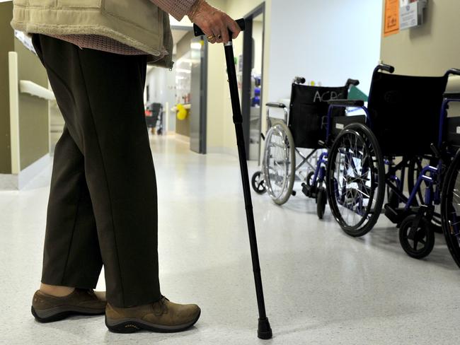 A woman uses a walking stick to assist her mobility in Canberra, Friday, May 24, 2013. (AAP Image/Alan Porritt) NO ARCHIVING