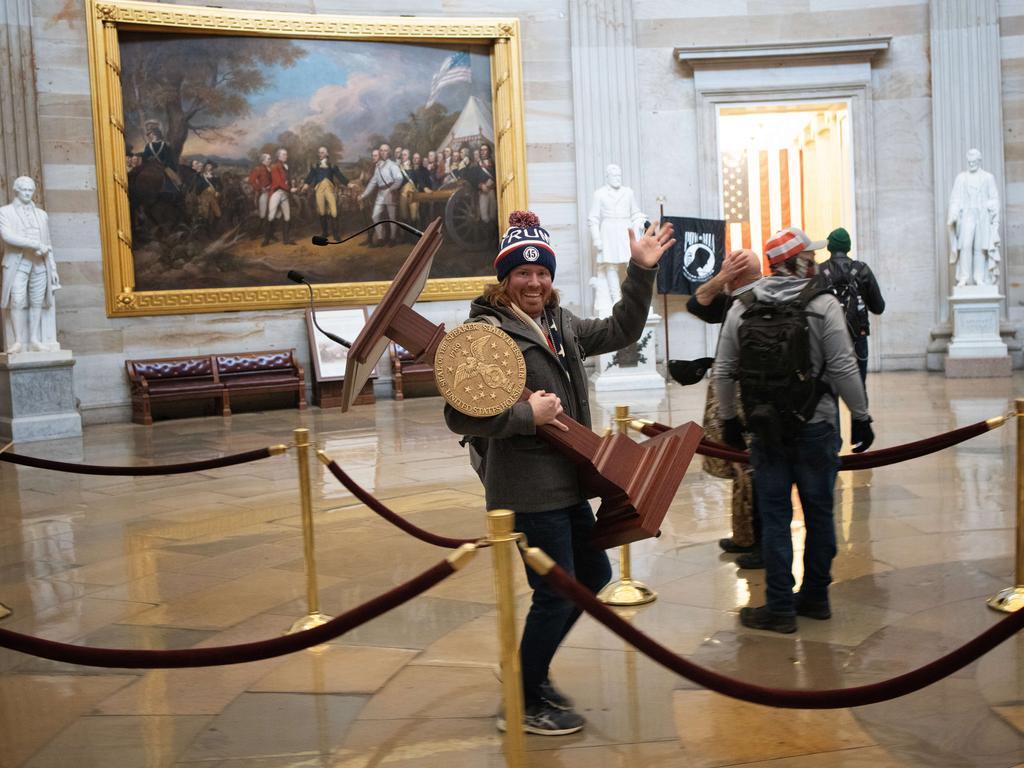 A rioter carries the lectern of US Speaker of the House Nancy Pelosi. Picture: Win McNamee/Getty Images/AFP