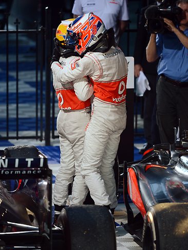 Teammate Lewis Hamilton hugs Button after the race. Picture: Michael Dodge