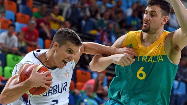 Serbian guard Bogdan Bogdanovic is harassed by Australian centre Andrew Bogut.