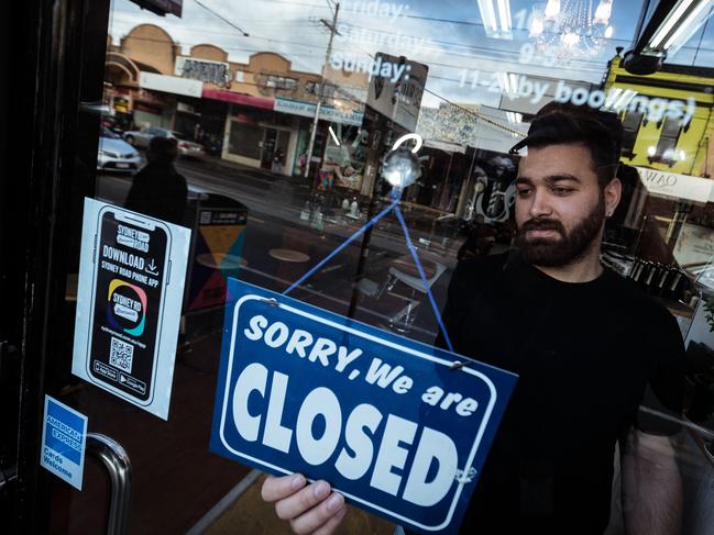 MELBOURNE, AUSTRALIA - AUGUST 05: Mas Azemi of Mas Barber Shop closes his shop on August 05, 2020 in Melbourne, Australia. Mas is the owner of Mas Barber Shop in Brunswick.  He has had to close the shop for 6 weeks and stand down 4 barbers. Retail stores across Melbourne will be closed to customers from 11:59 pm on Wednesday 5 August as further stage 4 lockdown restrictions are implemented in response to Victoria's ongoing COVID-19 outbreak.  The majority of retail businesses like clothing, furniture, electrical and department stores will be closed to the public for the duration of the stage 4 restrictions. Businesses will be able to operate click and collect services with social distancing and contactless payments. Supermarkets, grocery stores, bottle shops, pharmacies, petrol stations, banks, news agencies and post offices will remain open during the lockdown. Melbourne residents are subject to a curfew from 8pm to 5am, must stay within a 5km radius of their homes along with limits on hours of exercise, while all students have returned to home learning and childcare centres have closed. (Photo by Darrian Traynor/Getty Images)