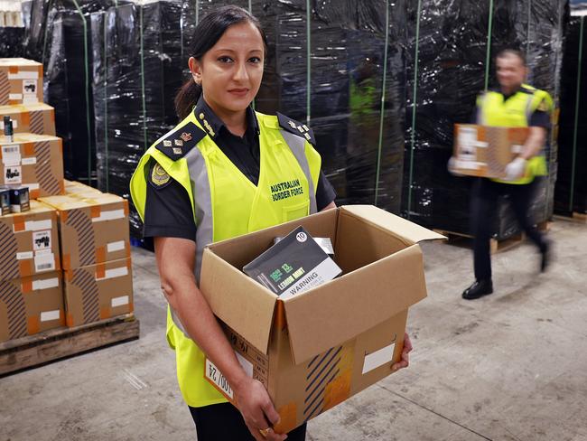 WEEKEND TELEGRAPH - 23.5.24MUST CHECK WITH PIC EDITOR BEOFRE USE - Acting Commander Trade East ADF, Asha Patwardhan (left) pictured with Superintendent Jared Leighton in Mascot today with illegal vapes intercepted in shipping containers. Picture: Sam Ruttyn