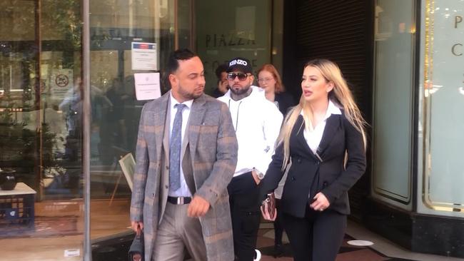 Kayla Attie (right) leaving court earlier this year supported by her partner (white hoodie).