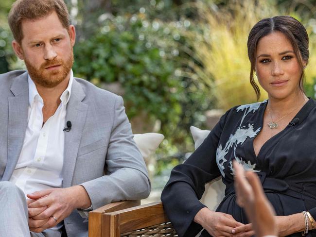 This undated image released March 7, 2021 courtesy of Harpo Productions shows Britain's Prince Harry (L) and his wife Meghan (C), Duchess of Sussex, in a conversation with US television host Oprah Winfrey. - Britain's royal family on March 7, 2021 braced for further revelations from Prince Harry and his American wife, Meghan, as a week of transatlantic claim and counter-claim reaches a climax with the broadcast of their interview with Oprah Winfrey. The two-hour interview with the US TV queen is the biggest royal tell-all since Harry's mother princess Diana detailed her crumbling marriage to his father Prince Charles in 1995. (Photo by Joe PUGLIESE / HARPO PRODUCTIONS / AFP) / RESTRICTED TO EDITORIAL USE - MANDATORY CREDIT "AFP PHOTO/ HARPO PRODUCTIONS -  Joe PUGLIESE" - NO MARKETING NO ADVERTISING CAMPAIGNS - DISTRIBUTED AS A SERVICE TO CLIENTS --- NO ARCHIVE ---