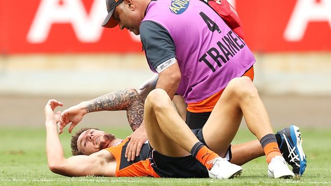 A trainer helps Daniel Lloyd after he hit the deck. Picture: Mark Kolbe/Getty Images