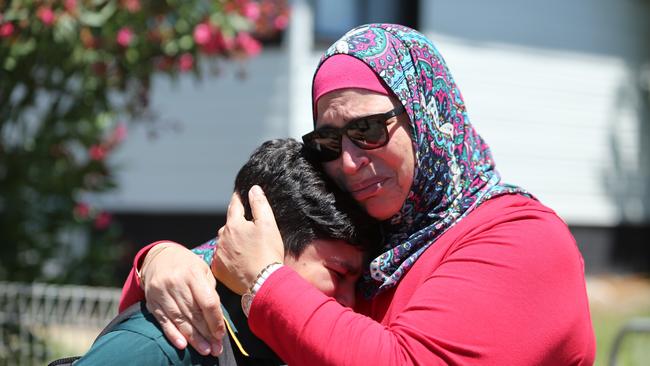 A mother comforts her child after the schoolyard tragedy. Picture: AAP