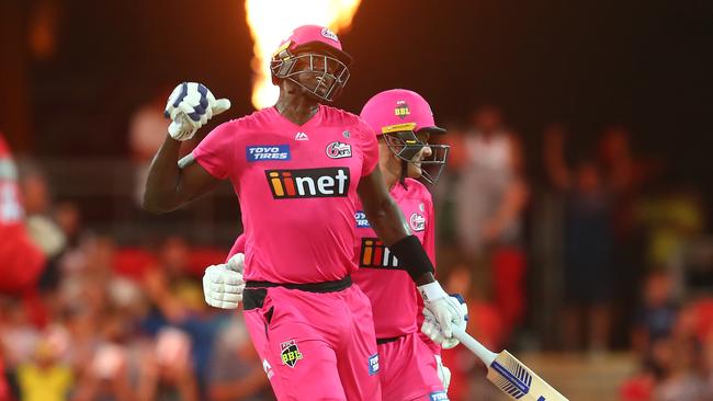 GOLD COAST, AUSTRALIA - DECEMBER 29: Jason Holder and Ben Manenti of the Sixers celebrate winning the Big Bash League match between the Melbourne Renegades and the Sydney Sixers at Metricon Stadium, on December 29, 2020, in Gold Coast, Australia. (Photo by Chris Hyde/Getty Images)