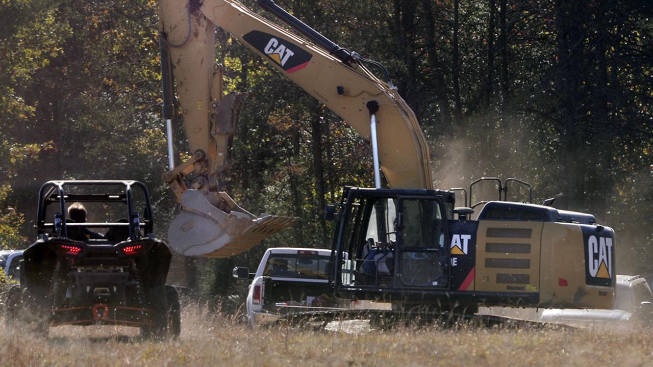 Investigators used heavy equipment to work the crime scene on Todd Kohlhepp’s property after his arrest. Picture: Tim Kimzey/The Spartanburg Herald-Journal via AP