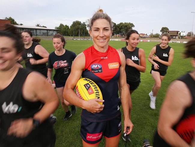 Melissa Hickey who plays for Melbourne FC, puts some young footballers through their paces at Coburg City Oval. Picture: Ian Currie