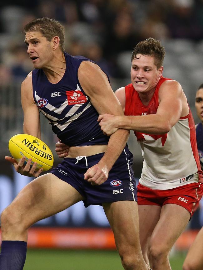 Hayden McLean tackles Aaron Sandilands during his AFL debut for Sydney. Picture: Paul Kane/Getty Images.