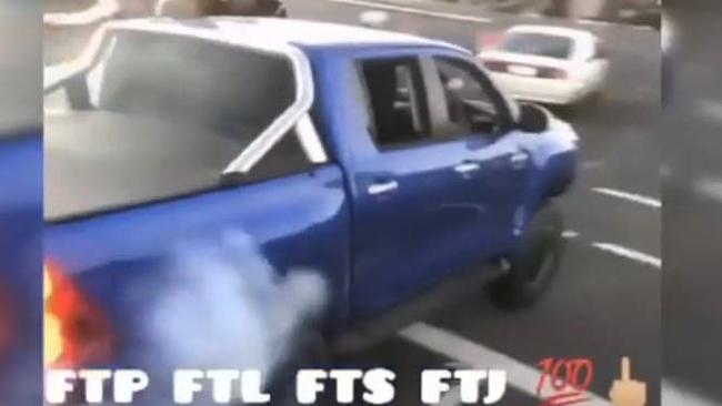 Alleged car thieves in a Toyota Hilux do burnouts and run a red light outside Pillow Talk on McCoombe St in June.