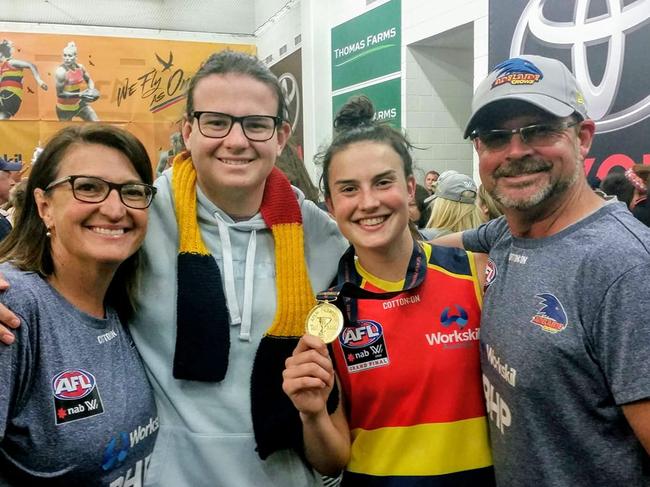 Crows AFLW player Eloise Jones pictured with her family after winning the 2019 AFLW premiership. She’s in the changerooms with her mum Philippa, brother Alec and dad Paul. Picture: Supplied Jones family 