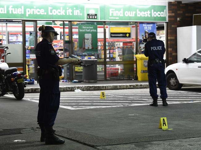 Police set up a crime scene at the Stanmore Rd service station. Exclusive Picture: Gordon McComiskie