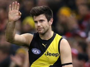 Trent Cotchin wearing a black armband.