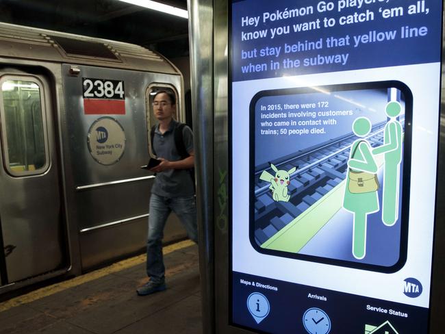 A safety message encouraging riders to be safe while playing Pokemon Go is displayed on a screen in the 14th Street subway station, New York City. Picture: AFP