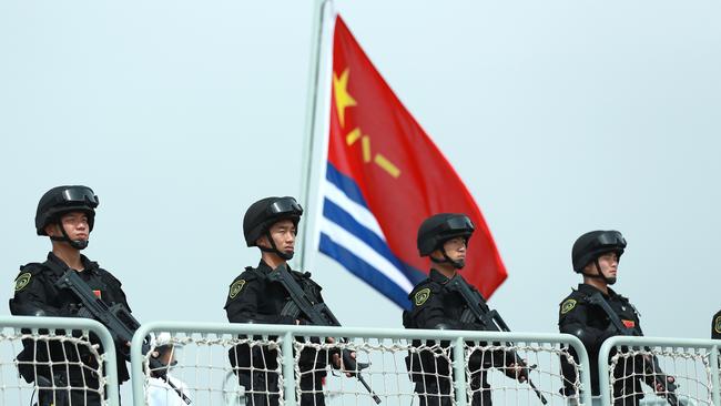 Members of the Chinese Navy stand on the deck of a navy ship in Zhoushan, Zhejiang Province. Picture: Getty Images.