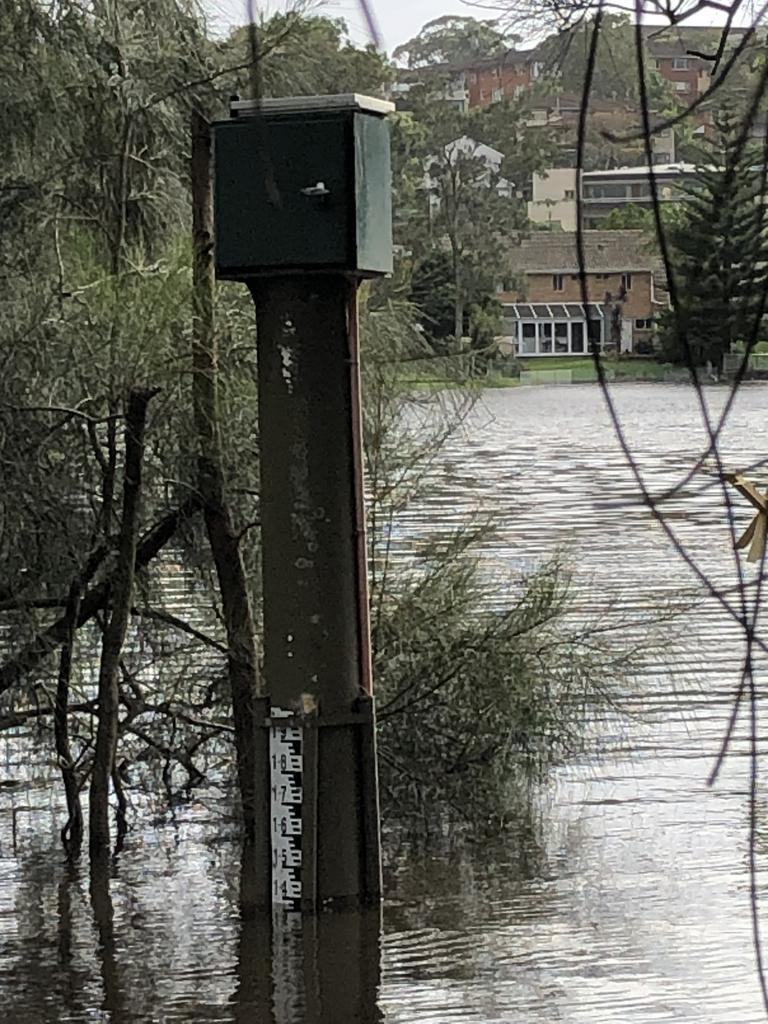 The flood gauge in Manly Lagoon, at the end of Riverview Pde, Manly, was already measuring close to 1.4m as water overlapping its banks on Wednesday morning, March 2, 2022. Picture: Jim O'Rourke