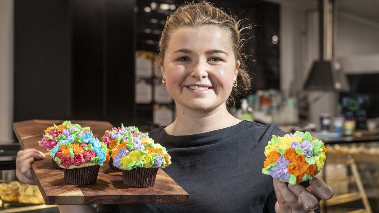 Zara Warby from CC's on the Range Bakehouse with some of their tasty carnival of flowers themed cupcakes. Wednesday, September 15, 2021. Picture: Nev Madsen.