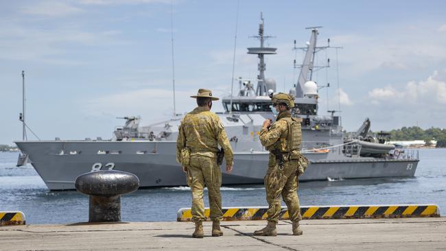 ADF members watch the HMAS Armidale sail into the Port of Honiara, Solomon Islands.