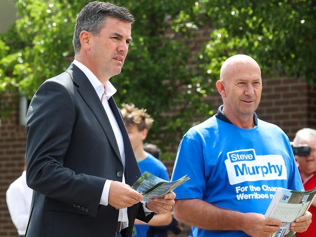 Opposition Leader Brad Battin hands out how-to-vote flyers at the polling booth at Manor Lakes P-12 College. Picture: Ian Currie