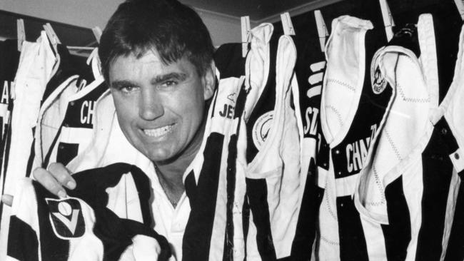  Greg Phillips surrounded by Port Adelaide and Collingwood jumpers.