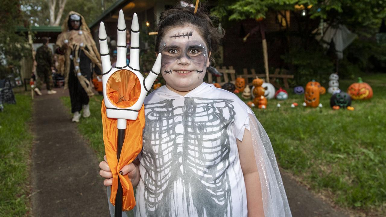 Ella Schmidt visits the Halloween display of Tiffany Crosbie. Monday, October 31, 2022. Picture: Nev Madsen.