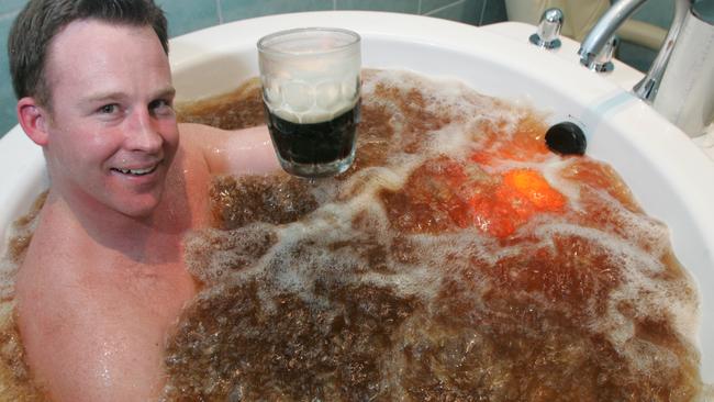 Liberal State Deputy Opposition Leader Will Hodgman enjoys a beer bath and a glass of beer at the Hobart Sanctuary day spa