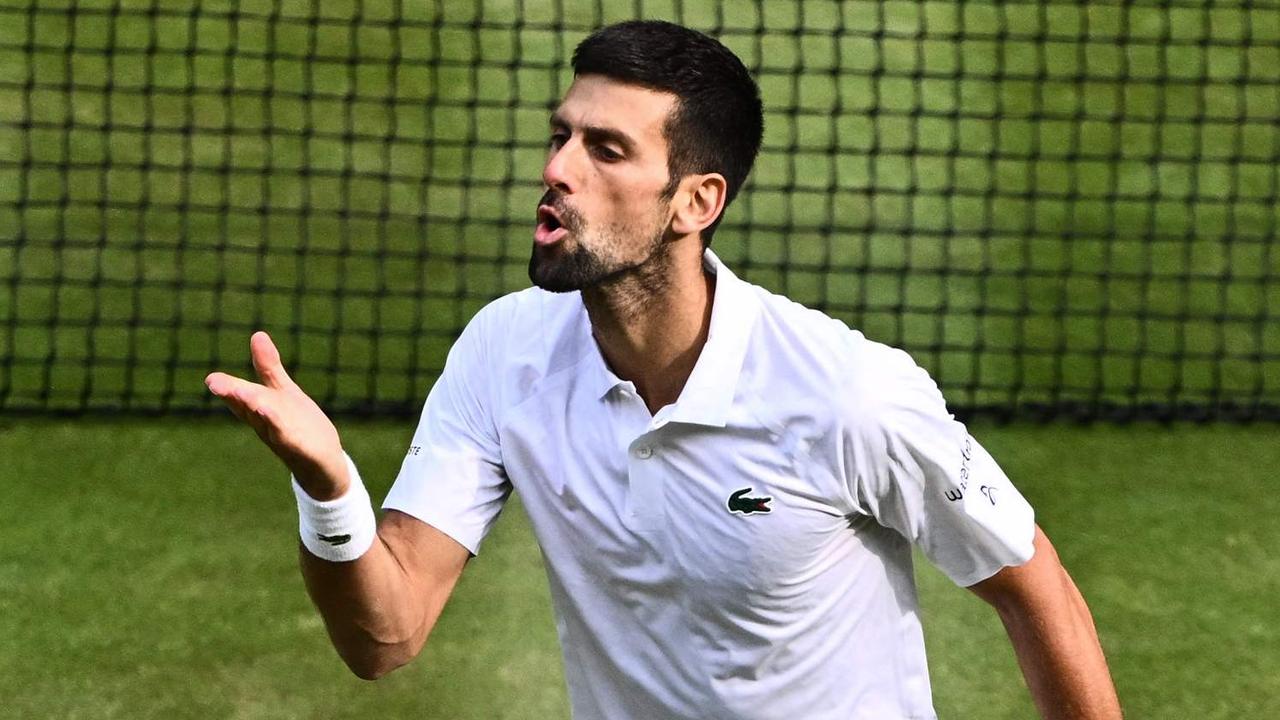 Novak Djokovic seals the break with a kiss. (Photo by SEBASTIEN BOZON / AFP)