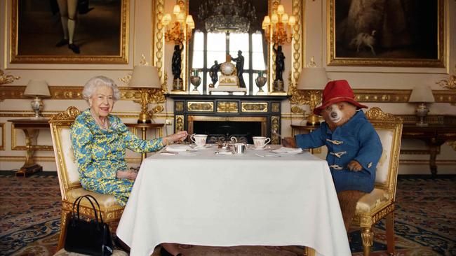 Queen Elizabeth II and Paddington Bear have cream tea at Buckingham Palace in June. Picture: Buckingham Palace via AFP