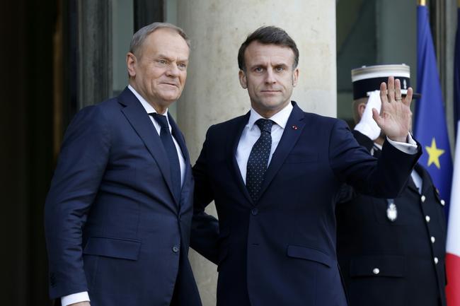 Polish Prime Minister Donald Tusk (L), pictured with French President Emmanuel Macron, said that he would urge European leaders at the emergency meeting to 'immediately' boost Europe's defences