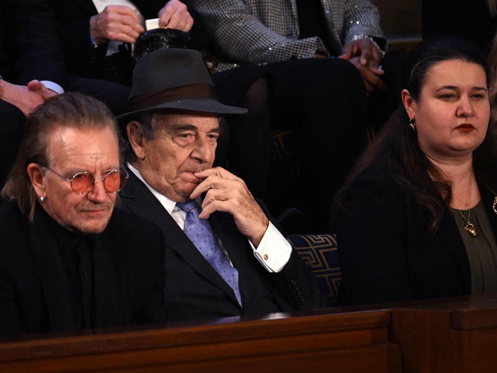 White House guests U2 frontman Bono and Paul Pelosi, husband of former US Speaker of the House Nancy Pelosi, and Ukrainian Ambassador to the US Oksana Markarova. Picture: AFP)