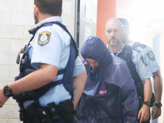 Tyron Knodler, wearing blue forensic suit, with police officers this morning  Picture: John Grainger