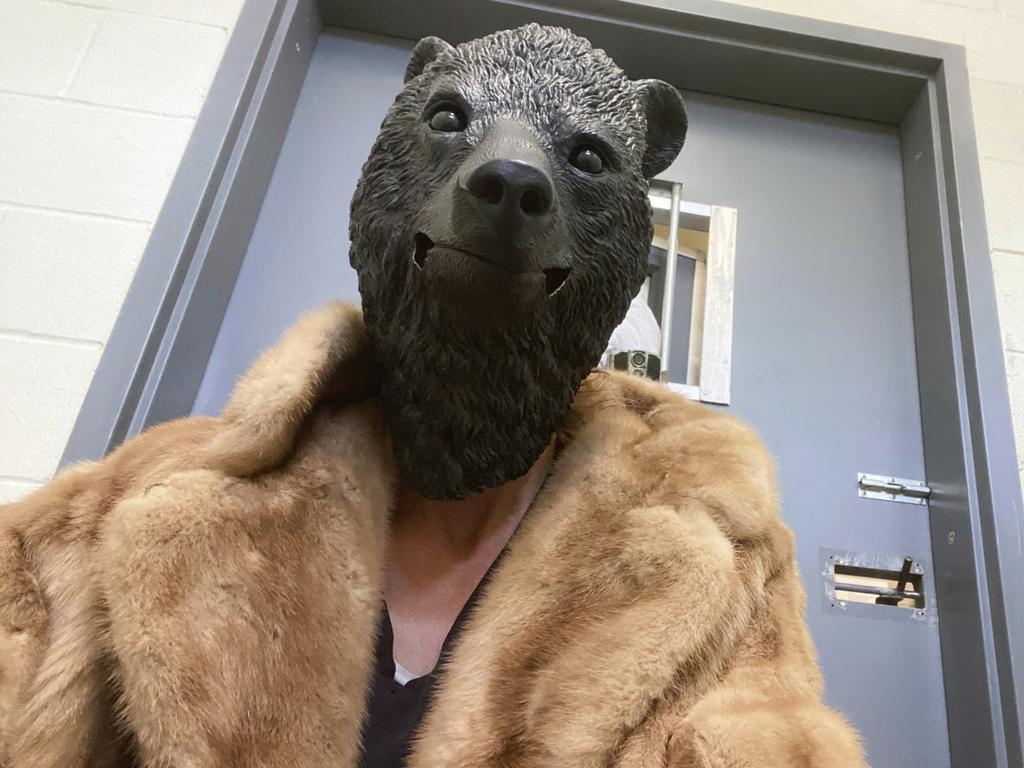 A Ramona Wildlife Center employee wears a mask before interacting with the bear cub, which was found alone in Los Padres National Forest. Picture: San Diego Humane Society via AP