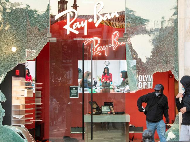 People are seen looting stores at the Grove shopping centre in the Fairfax District of Los Angeles. Picture: AFP