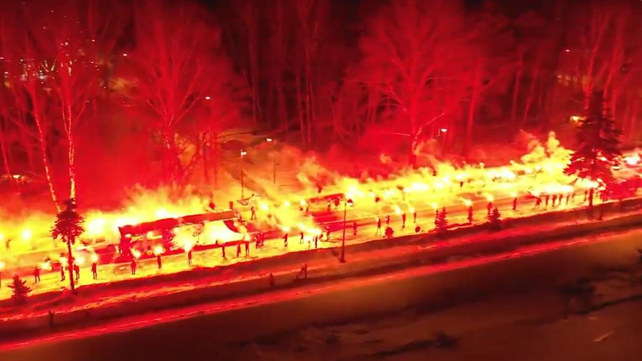 Zenit fans welcome their team with fire display.