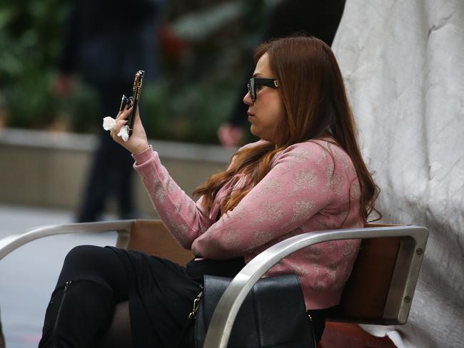 SYDNEY, AUSTRALIA - Newswire Photos - JULY 25 2023: People are seen on their mobile phones during lunch time in the Sydney CBD. Picture: NCA Newswire / Gaye Gerard