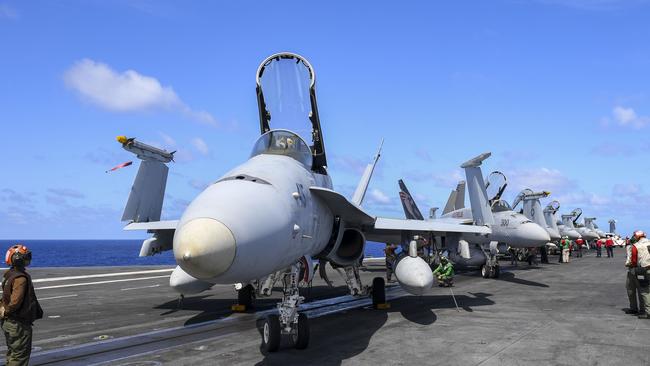 Preflight check are conducted FA18 fighter bombers on the USS Nimitz. Picture: US Navy